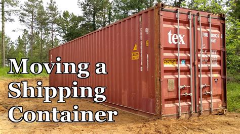 moving a shipping container with a skid steer|moving shipping containers with trailer.